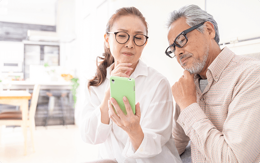Two people reviewing information on a phone