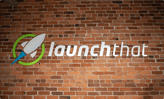 The Launch That logo on a brick wall in the office